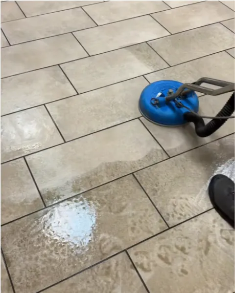 Rotary tool cleaning tile and grout on a kitchen floor